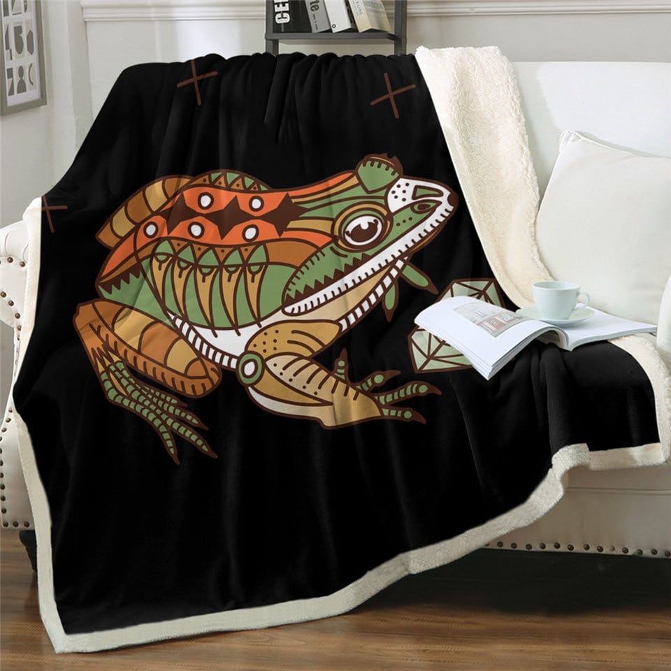 Plaid noir à motif grenouille imprimée sur un canapé