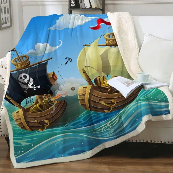 Plaid multicolore avec deux bateaux de pirate sur la mer posé sur un canapé blanc