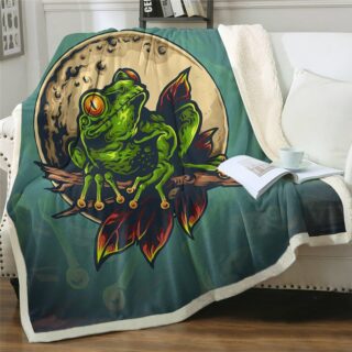 Plaid polaire vert avec grenouille imprimée sur un canapé