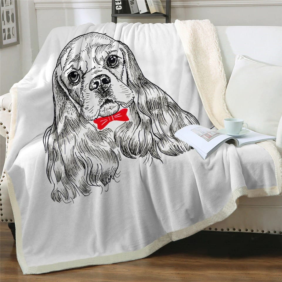 Plaid blanc avec motif chien 3D, un cavalier king charles, sur un canapé