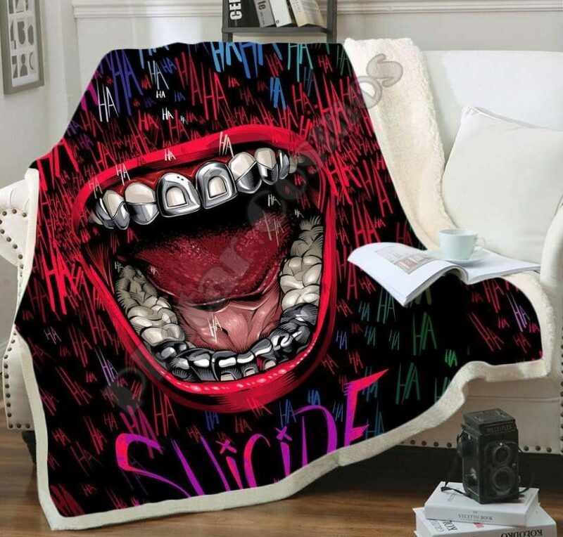 Plaid confortable avec motif Suicid Squad 3D sur un canapé blanc. Il ya un livre ouvert posé dessus avec une tasse blanche par dessus.