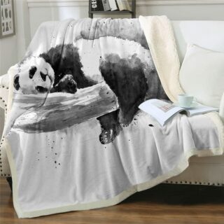 Plaid noir et blanc panda dormeur sur un canapé blanc
