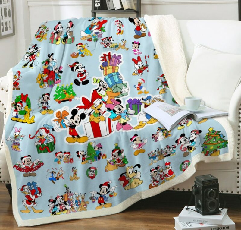 Plaid polaire multicolore avec motif Disney sur un canapé blanc
