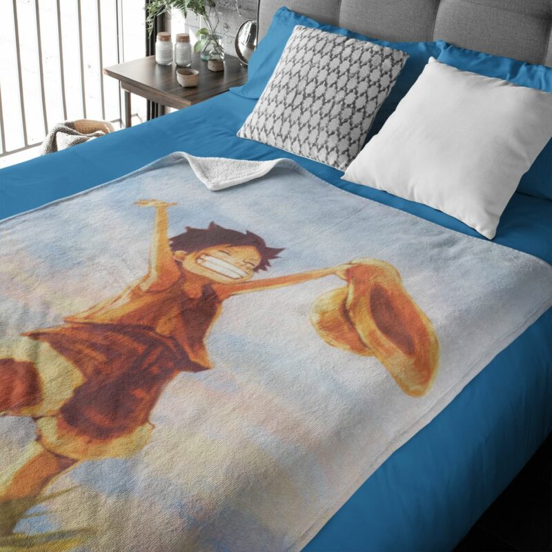 Un plaid one piece étalé sur un lit à la couverture bleue et la tête de lit grise.