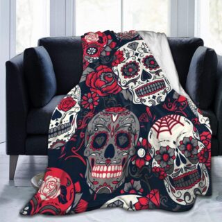 Plaid tête de mort mexicaines rouges et noires présenté sur un canapé noir